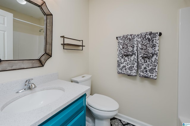 bathroom featuring vanity, toilet, and a shower