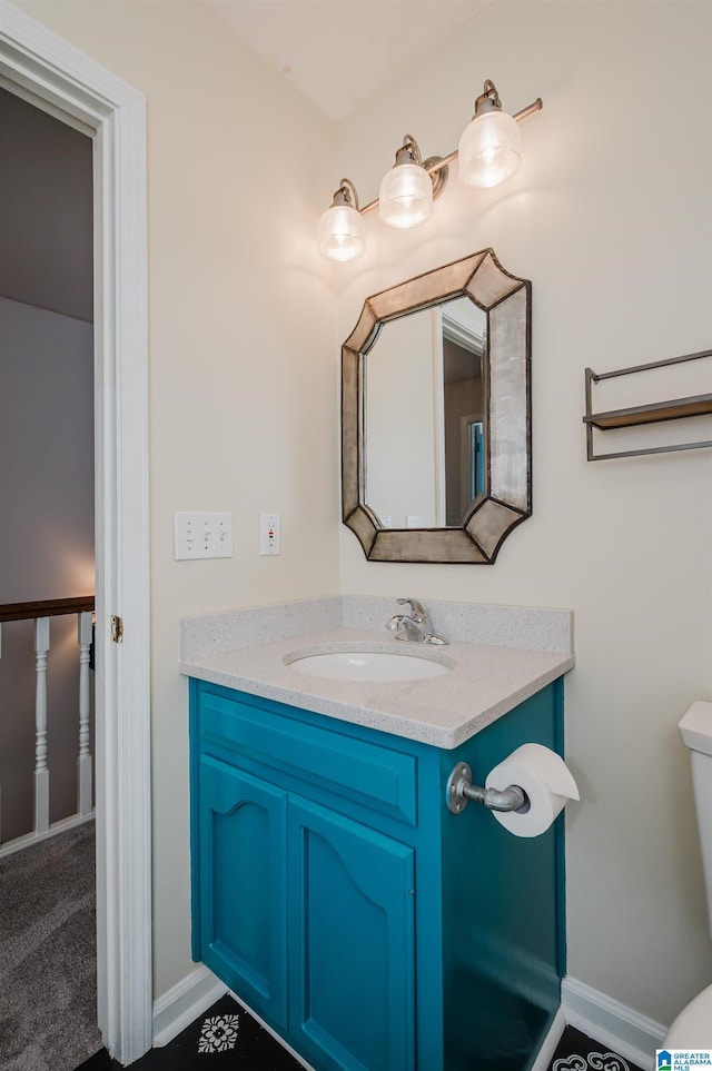 bathroom featuring vanity and toilet