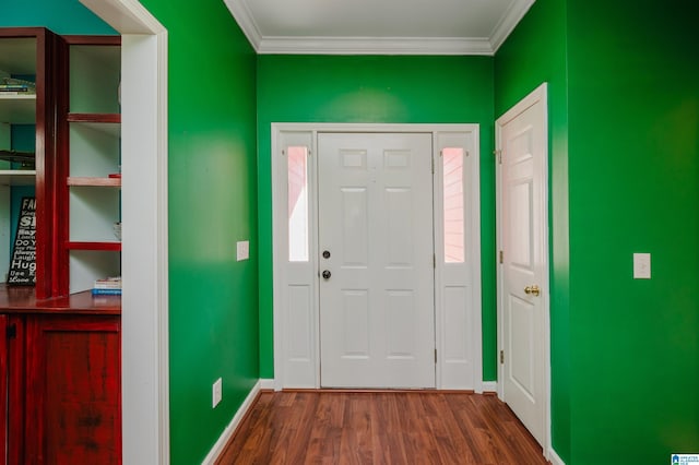 foyer entrance featuring crown molding and dark wood-type flooring