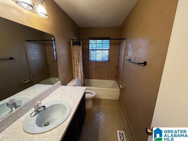 full bathroom with shower / bath combo, toilet, a textured ceiling, and vanity