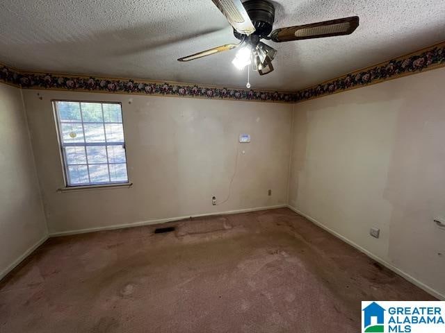 carpeted empty room with a textured ceiling and ceiling fan