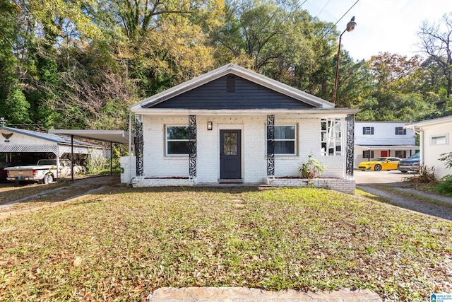 bungalow-style house featuring a carport and a front yard