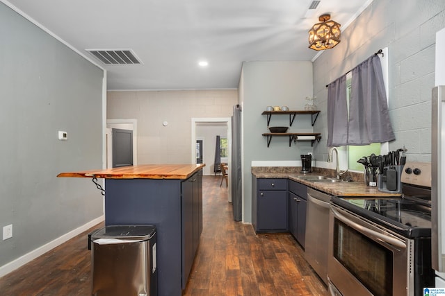 kitchen featuring butcher block counters, sink, dark hardwood / wood-style floors, appliances with stainless steel finishes, and ornamental molding