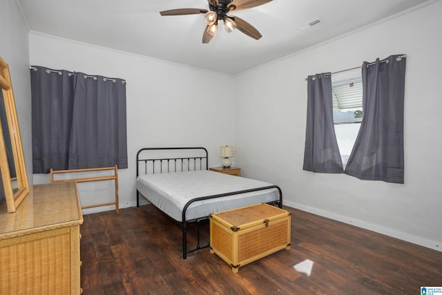 bedroom featuring ceiling fan, crown molding, and dark wood-type flooring