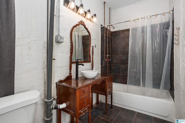 bathroom featuring tile patterned flooring, toilet, and shower / bath combo with shower curtain