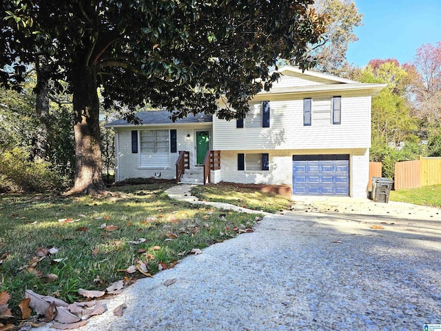 tri-level home featuring a front yard and a garage