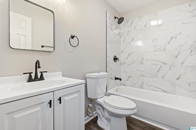 full bathroom featuring hardwood / wood-style flooring, vanity, toilet, and tiled shower / bath