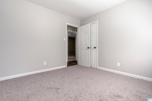 unfurnished bedroom featuring a closet and carpet floors