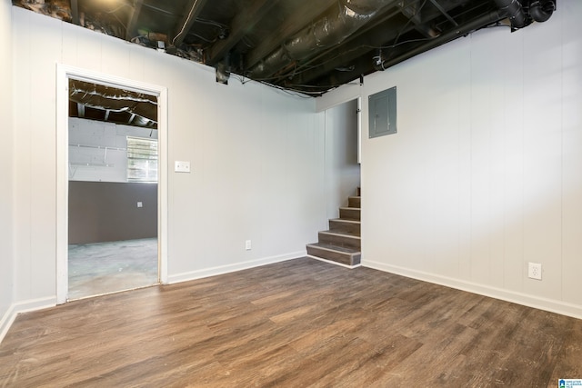 basement with hardwood / wood-style floors and electric panel