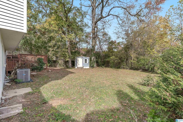 view of yard featuring a shed and central AC unit