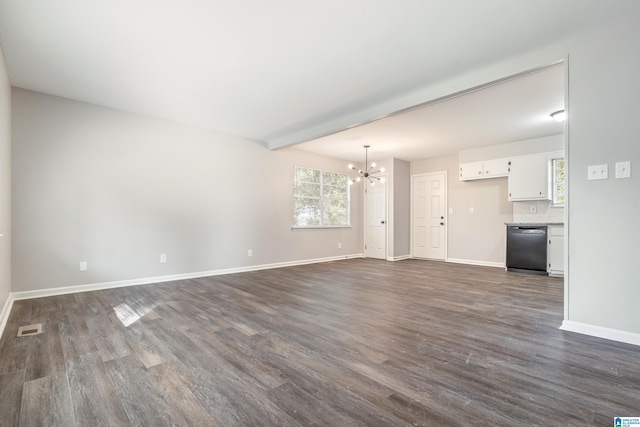 unfurnished living room featuring beamed ceiling, dark hardwood / wood-style flooring, and an inviting chandelier