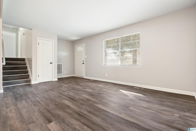 empty room with dark hardwood / wood-style flooring