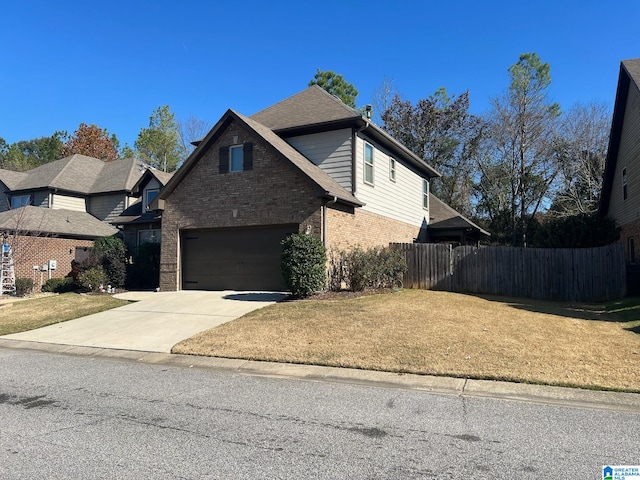 front of property featuring a front lawn and a garage