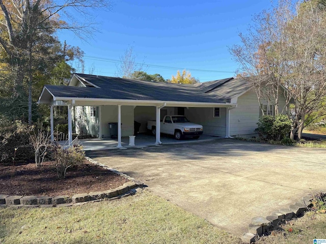 1807 Moncrief Rd, Gardendale, AL 35071 - view of side of property with driveway, an attached carport, and roof with shingles