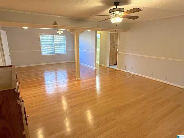 1807 Moncrief Rd, Gardendale, AL 35071 - spare room featuring ceiling fan, crown molding, light wood-style floors, a textured ceiling, and baseboards