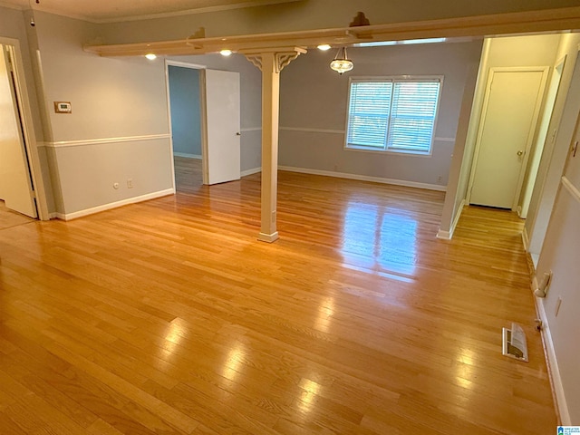 unfurnished room with light hardwood / wood-style floors and ornamental molding