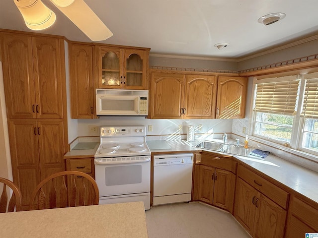 1807 Moncrief Rd, Gardendale, AL 35071 - kitchen featuring white appliances, a sink, light countertops, brown cabinetry, and ornamental molding