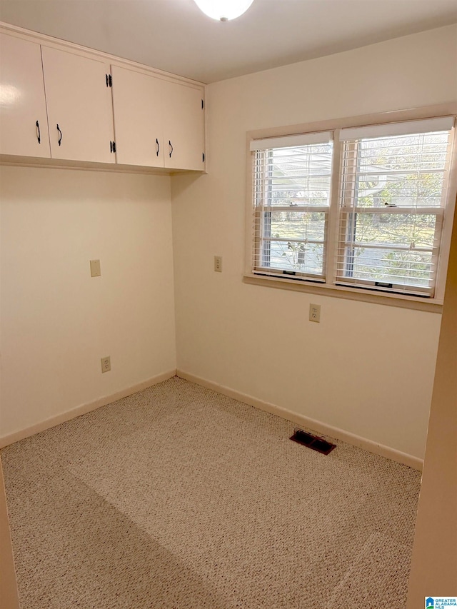 spare room featuring carpet floors