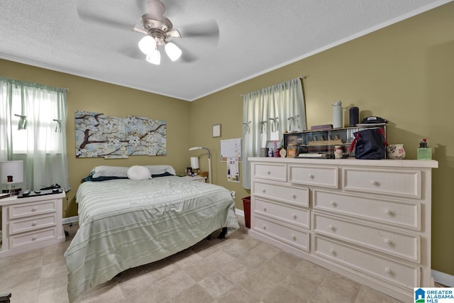 bedroom featuring a textured ceiling, ceiling fan, and crown molding