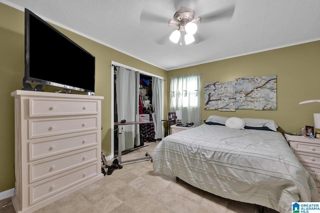 bedroom with ceiling fan, a textured ceiling, and ornamental molding