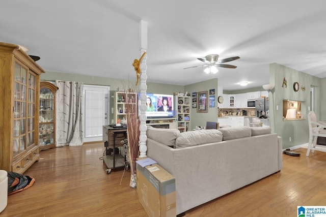 living room with ceiling fan and light hardwood / wood-style floors