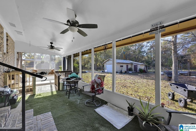 unfurnished sunroom featuring ceiling fan