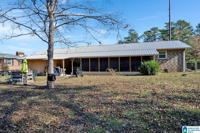 back of property with a sunroom