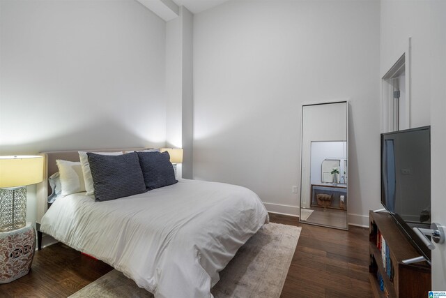 1801 2nd Ave N Unit 416, Birmingham, AL 35203 - bedroom with wood finished floors, a high ceiling, and baseboards