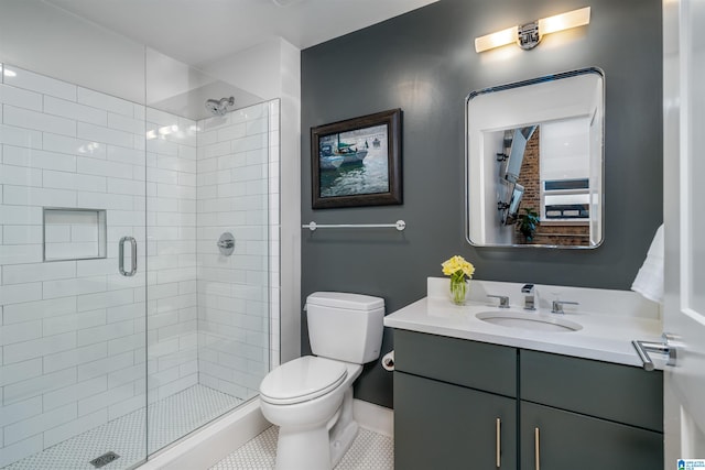 bathroom with tile patterned flooring, vanity, toilet, and a shower with door