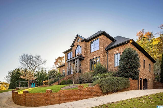 view of front of property with a front lawn and a garage