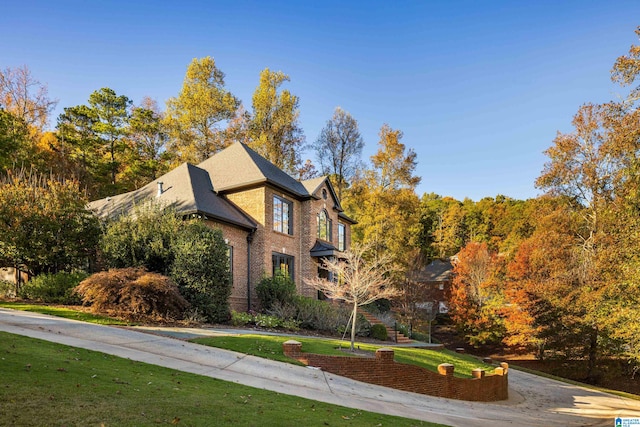 view of property exterior featuring a lawn