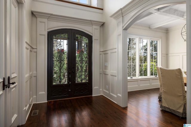 foyer entrance featuring coffered ceiling, beam ceiling, dark hardwood / wood-style flooring, and french doors