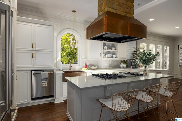 kitchen featuring custom range hood, white cabinetry, and a wealth of natural light