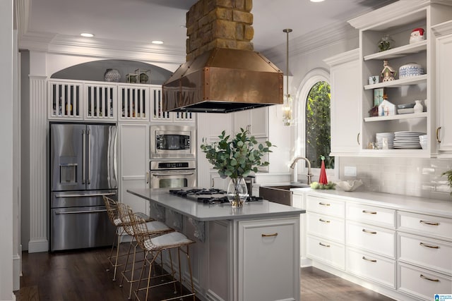 kitchen featuring a kitchen island, white cabinetry, sink, and appliances with stainless steel finishes