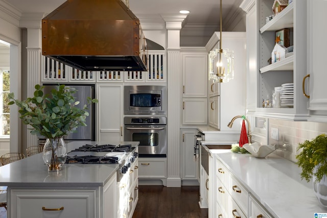 kitchen with white cabinetry, hanging light fixtures, custom range hood, and appliances with stainless steel finishes