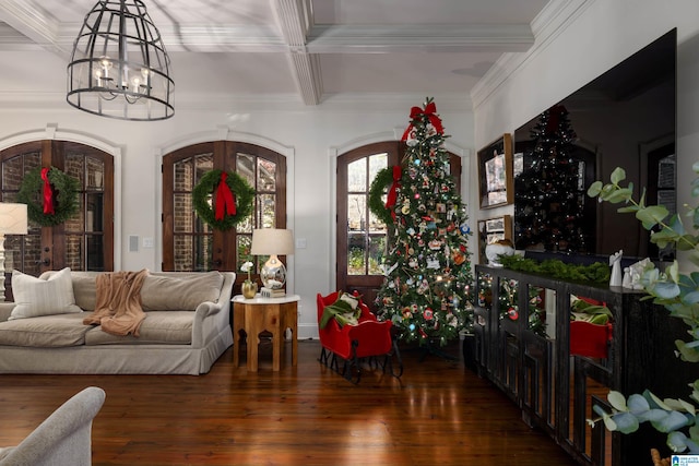 interior space with a notable chandelier, dark hardwood / wood-style floors, beam ceiling, and crown molding