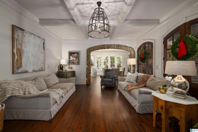 living room featuring coffered ceiling, crown molding, dark wood-type flooring, beam ceiling, and a notable chandelier