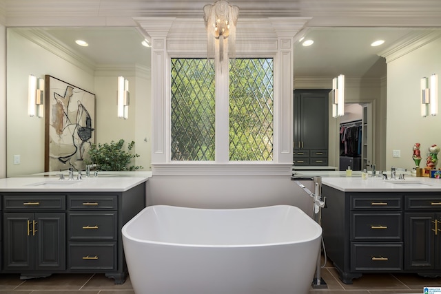 bathroom with a bathtub, vanity, ornamental molding, and tile patterned flooring