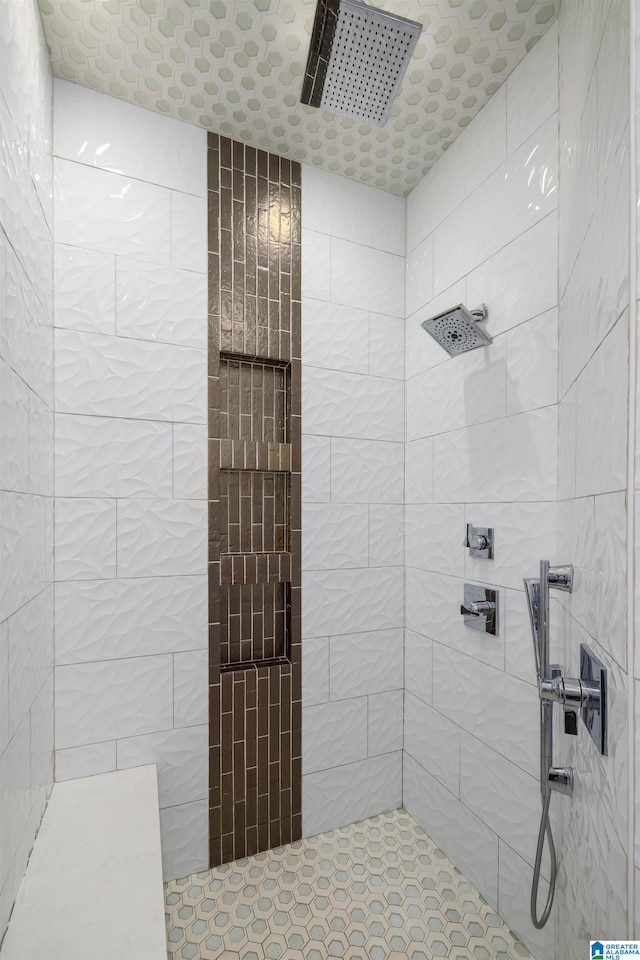 bathroom with a tile shower