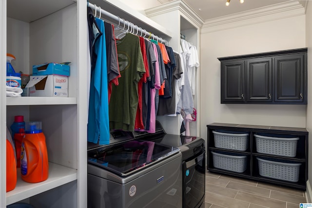 clothes washing area featuring separate washer and dryer and ornamental molding