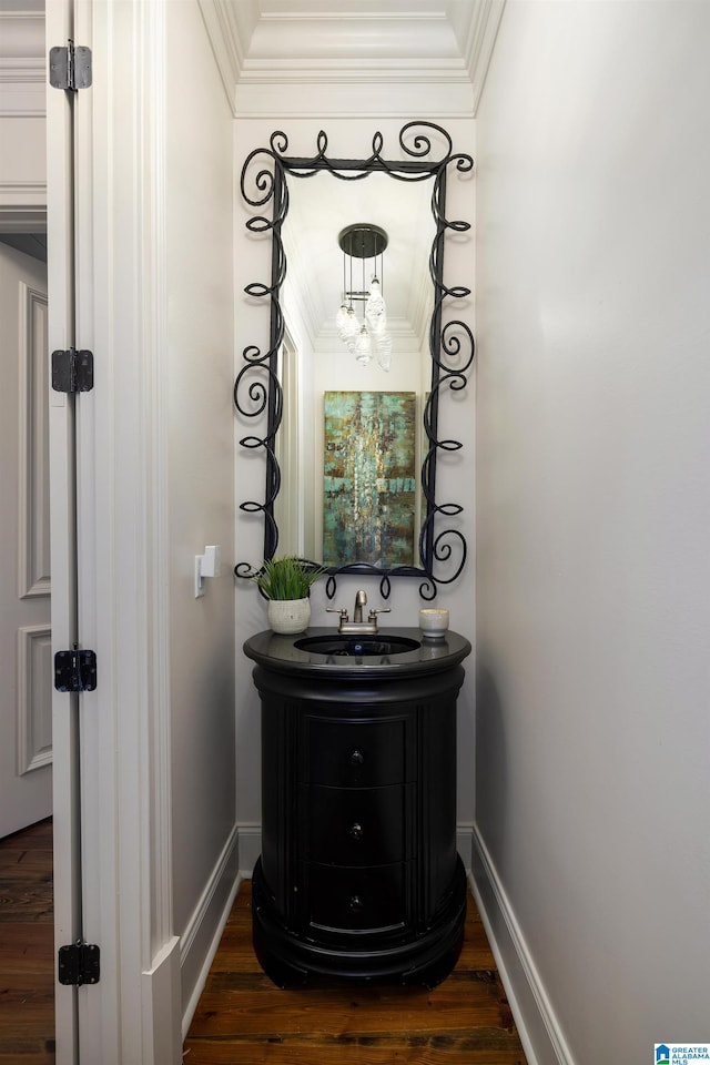 bathroom with hardwood / wood-style floors, vanity, and crown molding