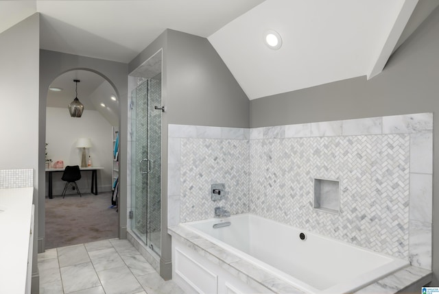 bathroom with separate shower and tub, lofted ceiling, and tile walls