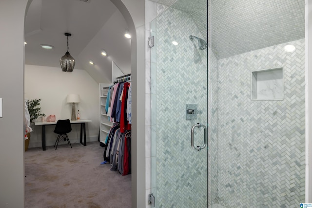 bathroom with vaulted ceiling and a shower with shower door