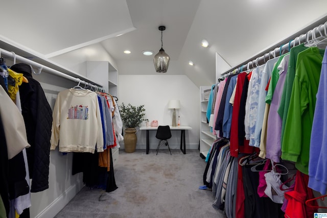 spacious closet featuring light colored carpet and vaulted ceiling