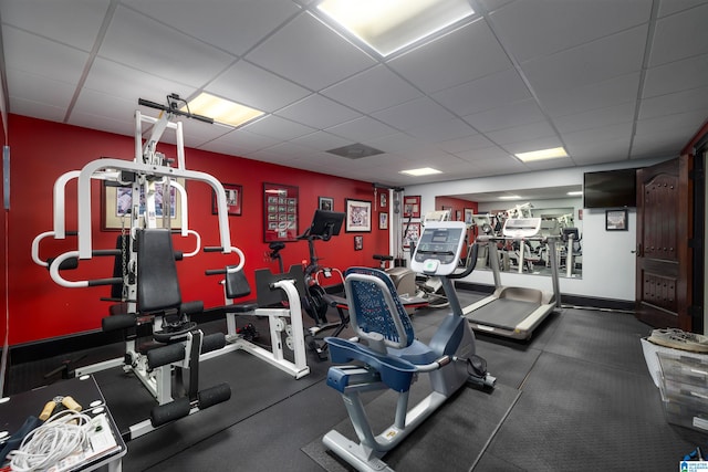 exercise room featuring a drop ceiling