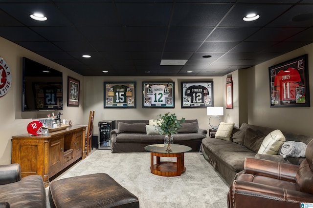 carpeted living room with a drop ceiling