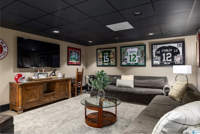 living room featuring carpet flooring and a drop ceiling