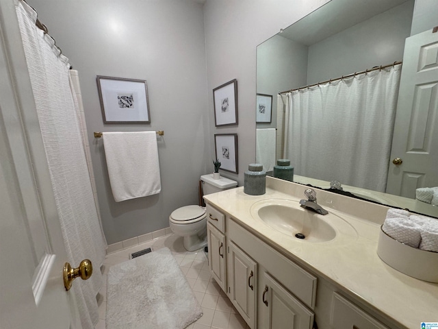 bathroom featuring vanity, tile patterned floors, and toilet