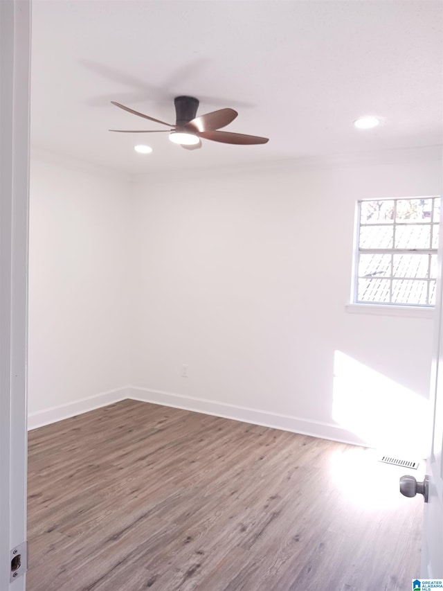 unfurnished room featuring ceiling fan and hardwood / wood-style flooring