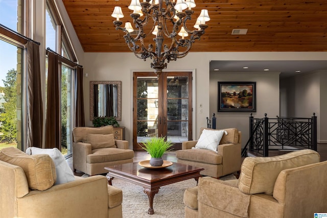 living room featuring lofted ceiling, hardwood / wood-style flooring, an inviting chandelier, and wooden ceiling